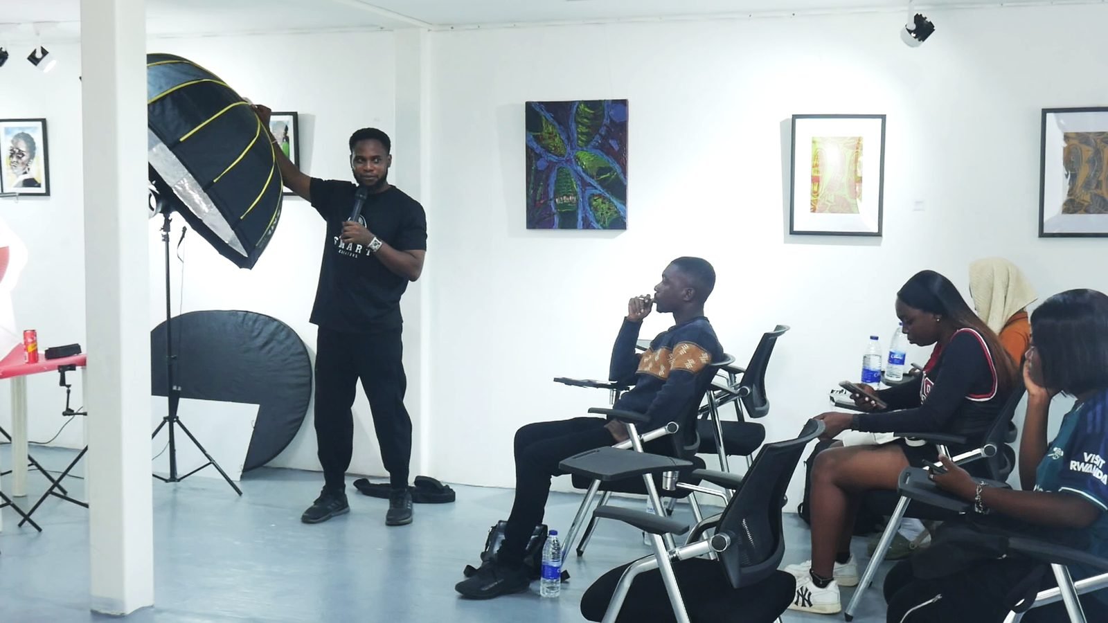 Tutor explaining lighting setup to attendees